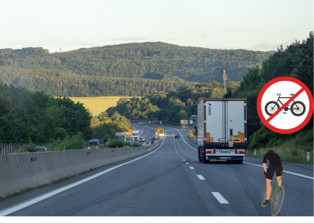 Grafika: Elżbieta Krząstek - Janeczko
Rowerzysta, droga szybkiego ruchu, ciężarówka, zakaz jazdy dla rowerów